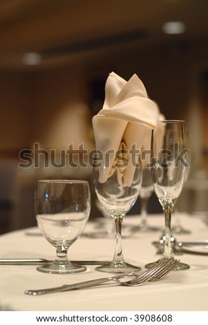 stock photo Elegant table setting at a wedding focus on the napkin in the