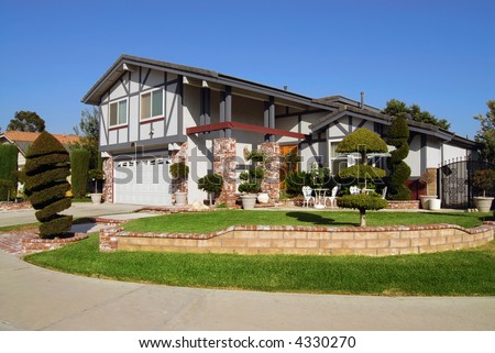 Beautiful suburban house with decorative shrubs and bushes