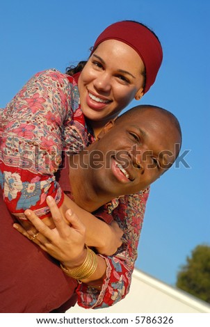 stock photo : Cute couple playing around outdoors on a bright sunny day