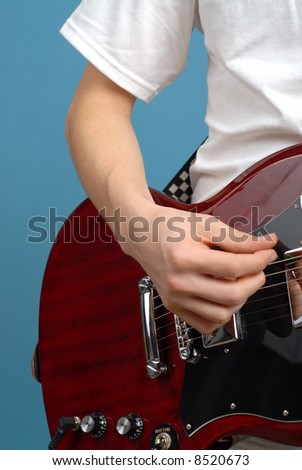 Vertical detail shot of an electric guitar player