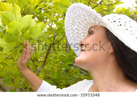 Older attractive woman in a casual outfit in a spring garden