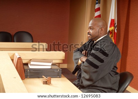 African American judge sitting in his courtroom while presiding over trial