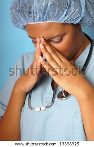 Crying nurse with her hands on her face