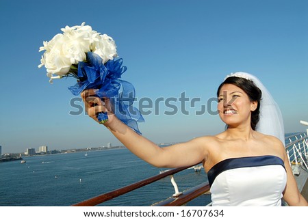 Bride at sea with her big bouquet of flowers