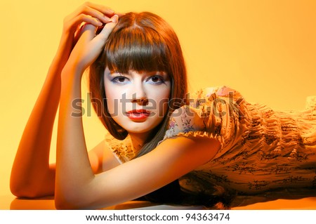 European fashion model with bright make up yellow red background