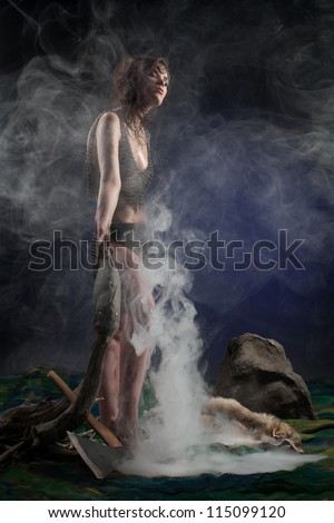 Amazon elegant with a fish in his hand in the smoke