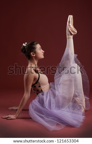 young beautiful ballerina with raised leg