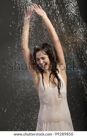 pretty young woman in the rain in a wet dress