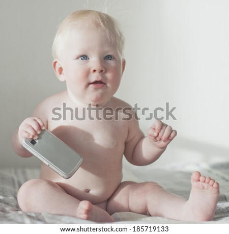 Cute adorable infant baby reaching out with hand asking for something while sitting,