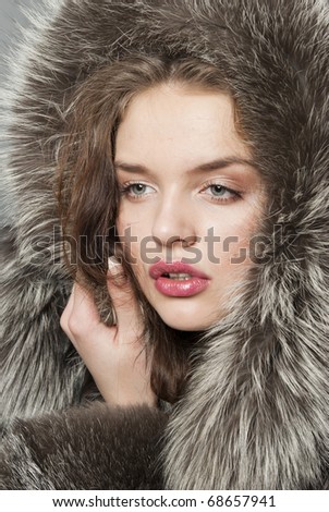 stock photo The young beautiful girl with chubby lips in a fur coat