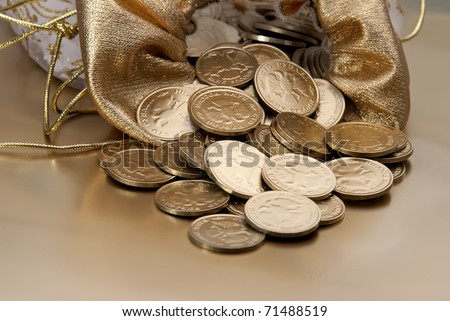 Bag with gold coins. Coins are scattered on a gold background