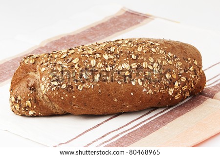 Long loaf of rye bread on a linen towel