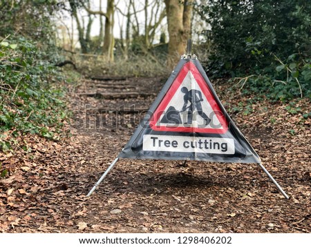Caution tree cutting sign in managed woodland tree surgery