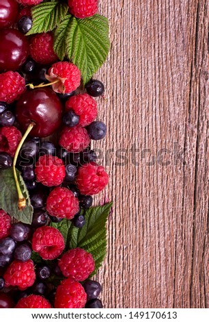 Berry mix left side of wooden background