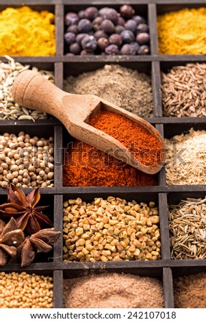 Various herbs and powder spices in box closeup