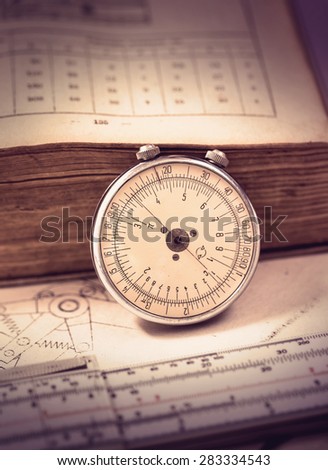 Rare mechanical slide-rule with old book and schemes