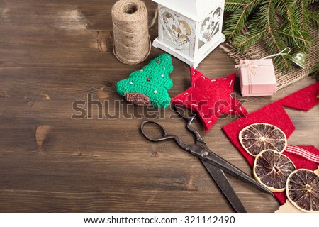 Various items for christmas hand craft at right top corner of wooden table