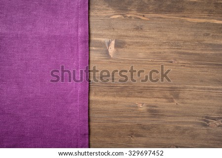Purple  napkin from left side wooden table top view
