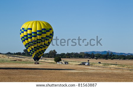 Hot air balloons are landing on a floor of Sacramento Valley in California.