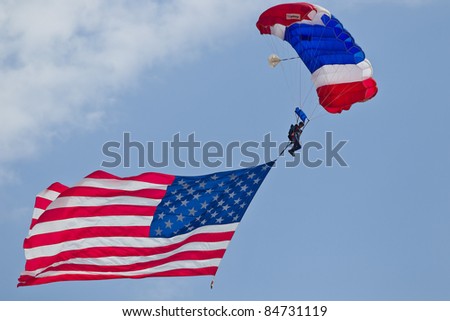 SACRAMENTO, CA - SEPT 10: Unidentified participant of California Capital Airshow dives from an airplane with the United States flag attached to his parachute on September 10, 2011 in Sacramento, CA.