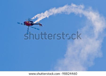 SALINAS, CA - SEPT 25: Pilot Chuck Aaron demonstrates the highest level of pilot skills on Red Bull aerobatic helicopter during the California International Airshow, on September 25, 2011, Salinas, CA
