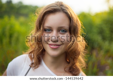 Outdoor portrait of young pretty women with ginger hair