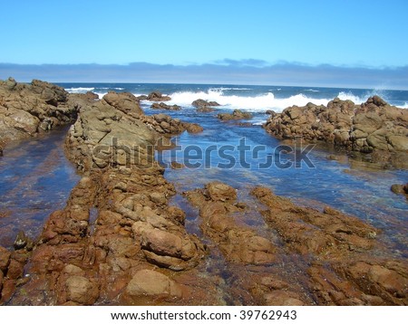 A rocky coast in Perth with high energy waves constantly crashing on it.