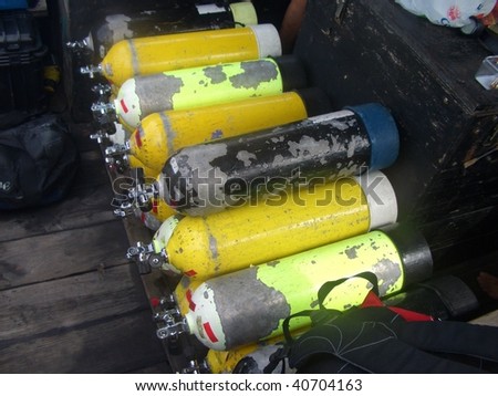 A stack of SCUBA tanks on a dive boat, ready to be used for the coming dives.
