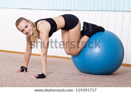 fitness woman doing exercises for muscle press with abs Swiss ball