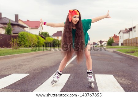 teenager his arms out to the side rollerblading. active lifestyle on  inline skates