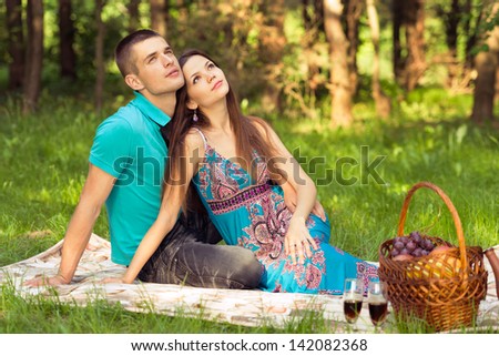 couple dreaming of future. outdoors portrait at picnic