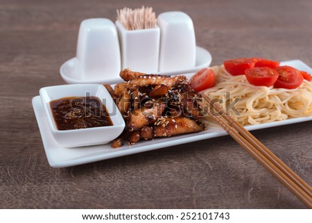 closeup pasta with chicken and two chopsticks chinese recipe