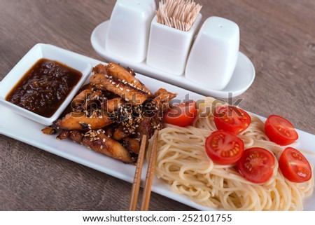 closeup pasta with chicken and sour-sweet sauce chinese recipe