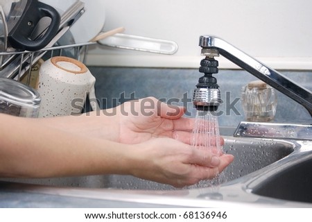 Kitchen Sink With Clean Dishes female hands being washed in the kitchen sink with clean dishes in Kitchen Sink With Clean Dishes female hands being washed in the kitchen sink with clean dishes in