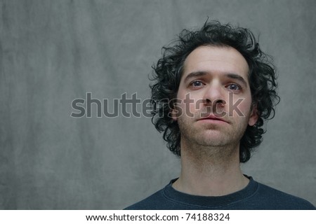 A Portrait of a Man with a Sad, Longing Expression on a Black and White Background with Room for Text