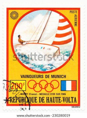 BURKINA FASO - CIRCA  1972: A stamp printed in Republic of Upper Volta, shows racing yacht, series Olympic Games, Munich, Germany, circa 1972