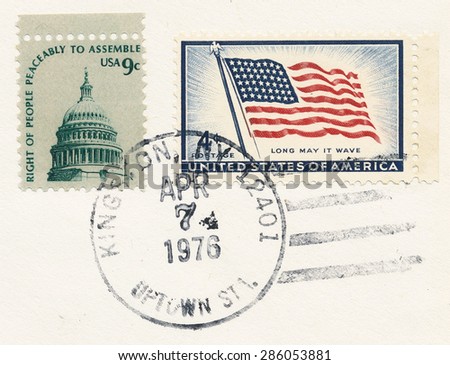 USA - CIRCA 1975: A stamp printed in USA shows Cut out of the mail envelope with two stamps, Dome of Capitol and Flag and stamp Apr. 7 1976 Kingston, circa 1975