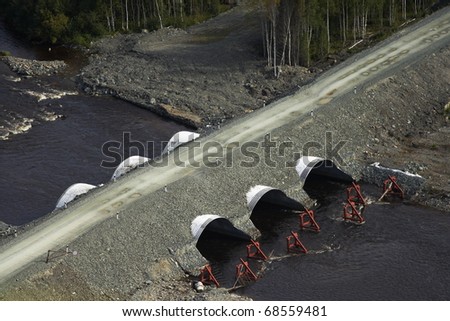 The top view on the pipes bridge through the river Tolja. Russia, Western Siberia.