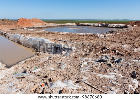 The surface of the well site with the drilling mud in Russia