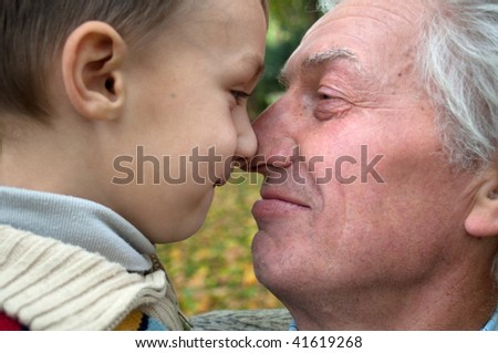 grandfather with grandson on nature face to face