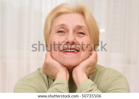 portrait of happy smiling elderly woman at home