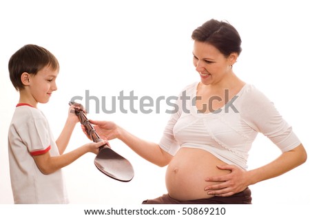 stock photo son gives his pregnant mom big spoon on a white background