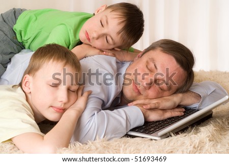 happy young father sleeps with his sons on a laptop