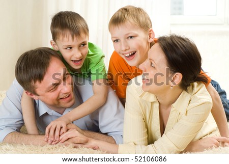 young parents play with their two sons