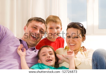 young parents play with their two sons
