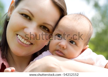 newborn in the arms of mother nature on the background