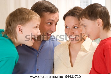 family of four standing together and surprise talks