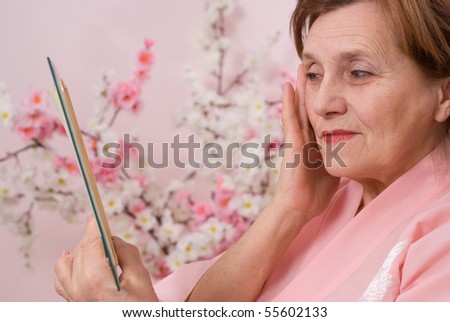 elderly woman with a mirror