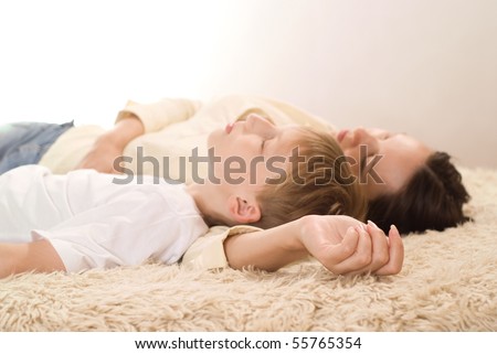 stock photo mom and son sleeping on the carpet