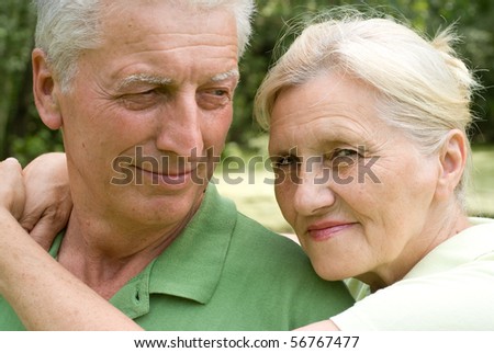 happy elderly couple in a summer park